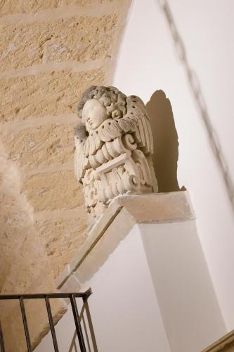 a statue on the side of a building at L'abadessa in Nardò