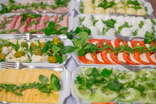 a buffet of different types of food in trays at Folwark Walencja in Kazimierz Dolny