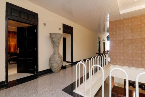 a room with a staircase and a vase on the wall at RedDoorz Plus near Halim Perdanakusuma 2 in Jakarta