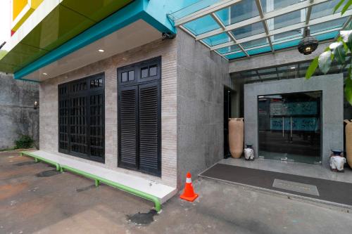 a building with a green bench in front of it at RedDoorz Plus near Halim Perdanakusuma 2 in Jakarta