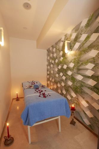 a bedroom with a bed with a blue blanket at Life Corner Hotel in Izmir