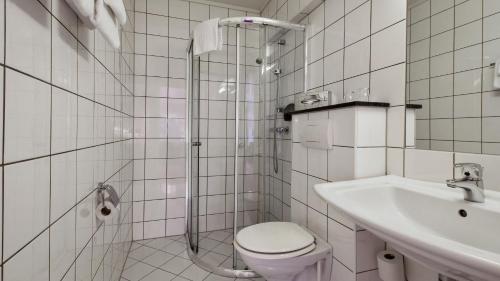 a bathroom with a shower and a toilet and a sink at Thon PartnerHotel Baronen in Ålesund