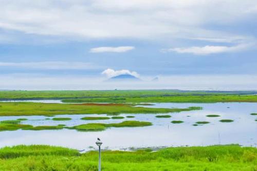 a large body of water with green islands in it at Lanyang Beach Villa in Wujie