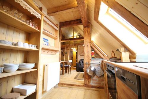 a kitchen with wooden walls and wooden floors at Ferienhaus Anno Dazumal, wie zu Opa`s Zeiten in Klingenthal