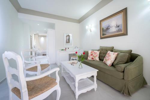 a living room with a couch and a table at Zephyros Hotel in Kamari