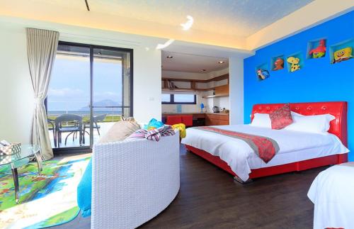 a bedroom with two beds and a sliding glass door at Lanyang Beach Villa in Wujie