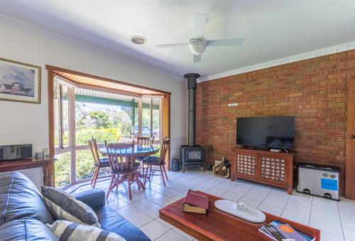 a living room with a couch and a table at Fairy Wren Cottage Country to Coast Retreat in Wallington