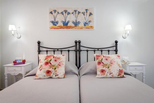a bedroom with a bed with two pillows at Zephyros Hotel in Kamari