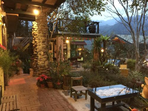 a patio with a table and a building at Old Farmer Homestay in Zhudong