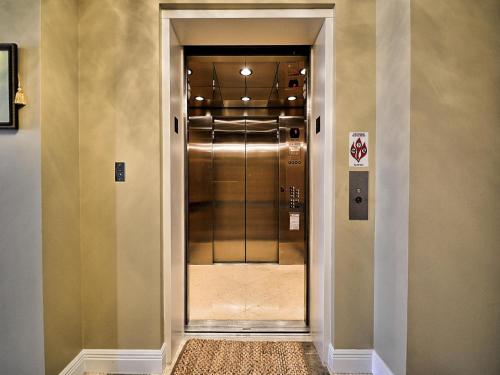 a hallway with a door leading to a elevator at Aqualea 504 in Clearwater Beach