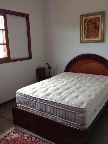 a mattress sitting on a bed in a bedroom at Morada Guaruja in Palhoça