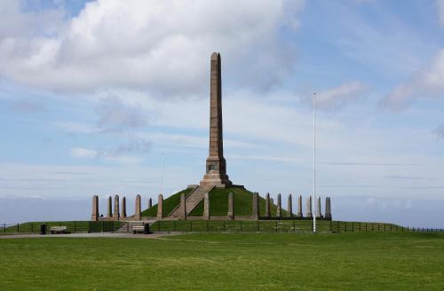 a monument with a tall obelisk in a field at Haraldshaugen Camping in Haugesund