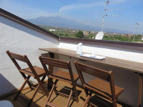 a table and two chairs on a balcony with a view at Case Vacanze Residence Trinacria in Acireale