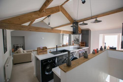 a kitchen with a stove top oven in a room at Red Rose Cottage in Cockermouth