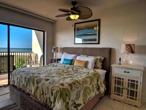 a bedroom with a bed with a view of the ocean at Surfside Condos 202 in Clearwater Beach