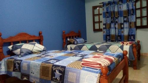 2 letti singoli in una camera con pareti blu di Casa de las NONAS a Salta