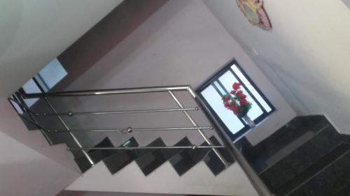 a stairwell with a glass shelf and a vase of flowers at Juliet's Homestay in Cochin