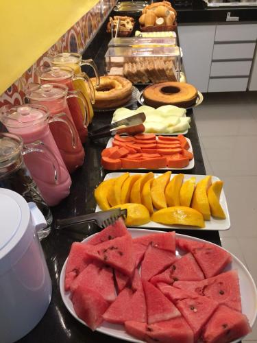 a buffet with different types of fruits and vegetables at Hotel Caroline in Timon