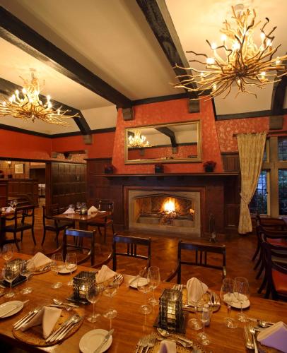 a dining room with a table and a fireplace at The Aberdare Country Club in Mweiga