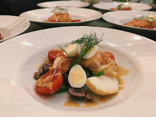 a plate of food with vegetables on a table at Serendipity Country House & Restaurant in Wilderness