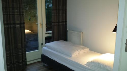 En eller flere senge i et værelse på Bospark Nuwenspete