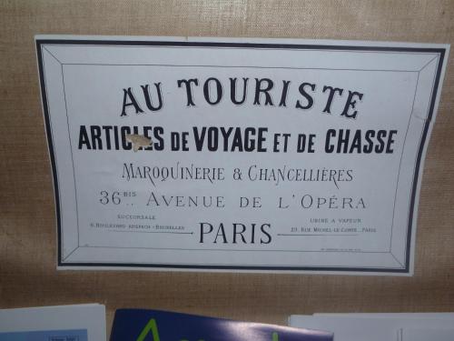 a framed sign on a wall with a sign for a museum at Chambre d'Hôtes Les Augustins - Parking sécurisé - Borne de recharge in Huy
