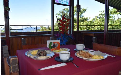 a table with three plates of food on it at Mirador Valle del General in La Ese