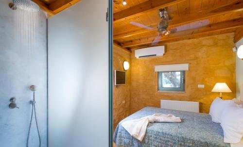 a bedroom with a bed and a wooden wall at Olea Prime in Marathi