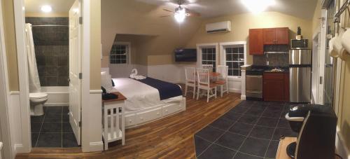 a bedroom with a bed and a bathroom at The Beachwood in Old Orchard Beach