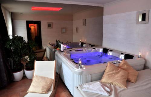 a hotel room with a tub and a couch at Villa St. Tropez in Prague