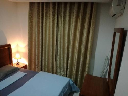 a bedroom with a bed and a window with curtains at Le luxe du Lac 2 in Berges Du Lac