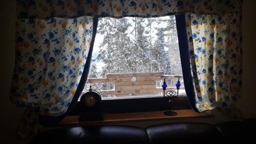 a window with a view of a snow covered tree at Rogla - Chalet Mojca Pokrajculja in Zreče
