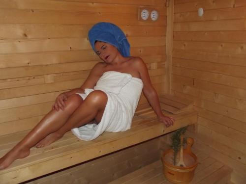 a woman is sitting in a sauna at Complejo Turístico & Camping Cabopino in Marbella