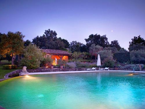 a large swimming pool in front of a house at Villa Elaiza in Saint-Tropez