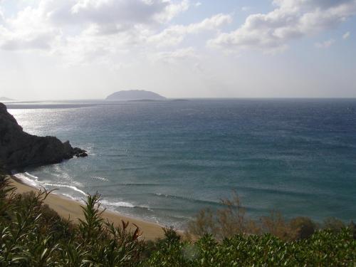 a view of the ocean with a beach and an island at Apollon Village Hotel in Anafi
