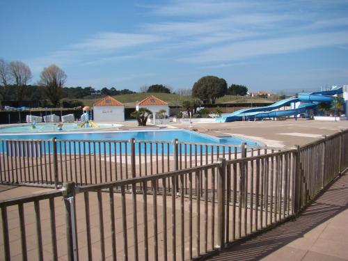 une piscine dans un parc avec une clôture dans l'établissement Ile au Pré vue lac et golf, à Talmont-Saint-Hilaire