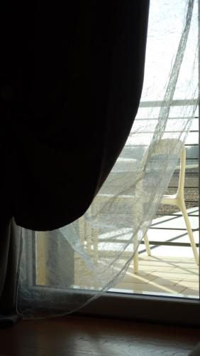 a window with a curtain and a chair in a room at Magrine Castelfranco Veneto in Castelfranco Veneto