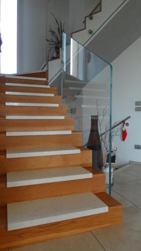 a staircase with wooden steps and a glass railing at Magrine Castelfranco Veneto in Castelfranco Veneto