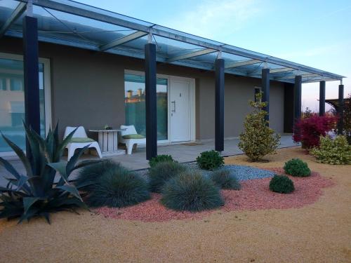 a house with a patio with a table and chairs at Magrine Castelfranco Veneto in Castelfranco Veneto