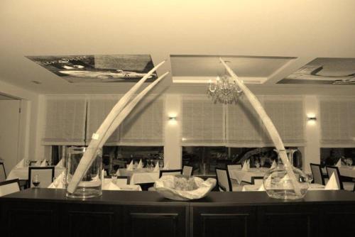 a dining room with two vases on a table at Hotel Hamann in Balingen