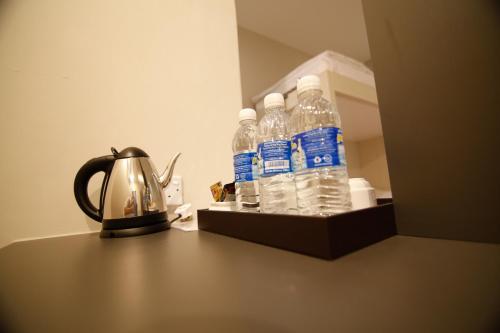 a group of bottles of water sitting on a table at Art Cottage Hotel in Ipoh