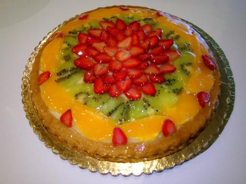 a cake with fruit on top of it on a table at Magrine Castelfranco Veneto in Castelfranco Veneto