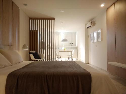 a bedroom with a bed and a desk in a room at Departamentos Lugar in Cordoba