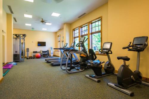 a gym with a row of exercise bikes and treadmills at The Lodge at Mountaineer Square in Mount Crested Butte