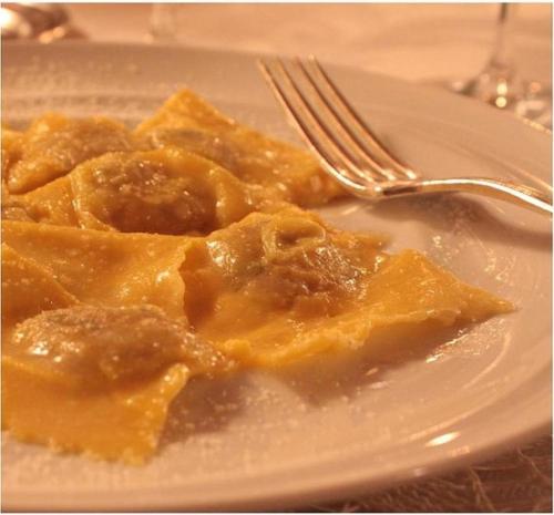 a plate of food on a table with a fork at Terme Di Monte Valenza in Valenza