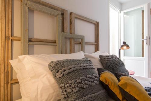 a bed with two pillows on top of it at Amymone Suites in Nafplio