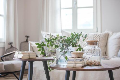 a living room with two tables with jars and plants at Amymone Suites in Nafplio