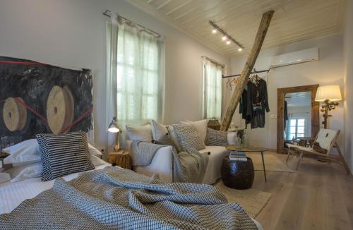 a bedroom with a bed and a living room at Amymone Suites in Nafplio