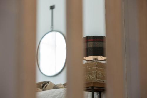 a mirror in a room with a bed and a table at Amymone Suites in Nafplio