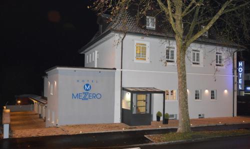 a white building with a sign on the side of it at Hotel Mezzero in Waldshut-Tiengen